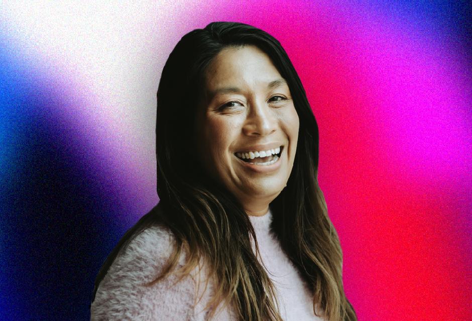 Smiling woman with long hair against a vibrant pink and blue gradient background.